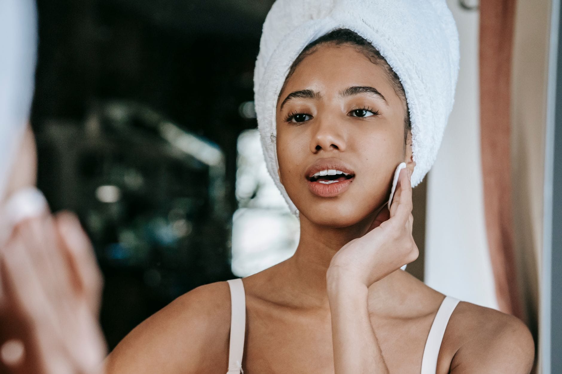 woman applying facial toner