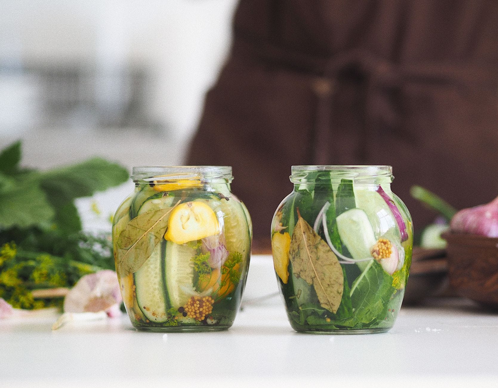 Whole dill pickles packed in brine inside a clear glass jar