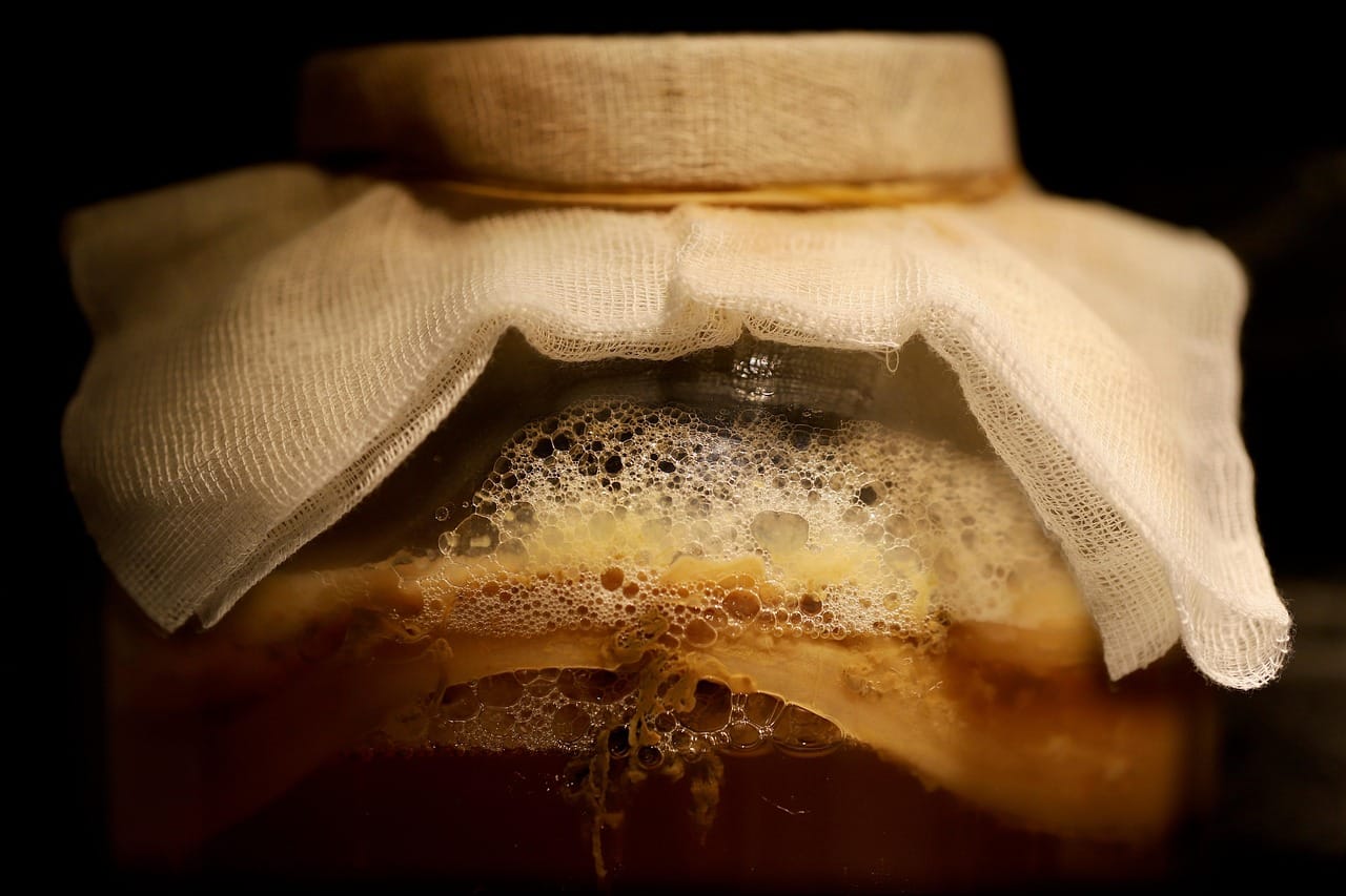 Pickled bamboo shoots packed in a clear glass jar of brine