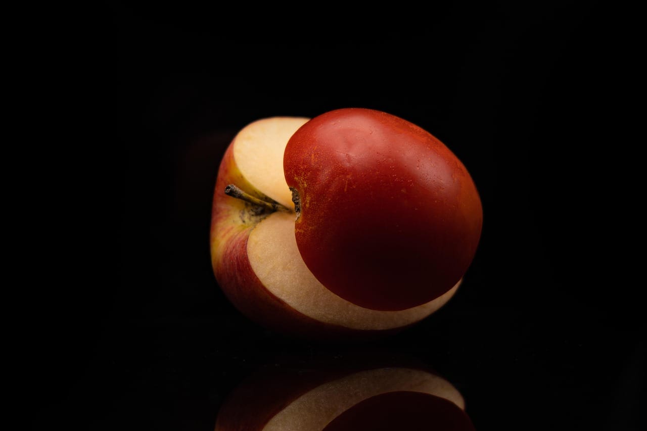 Halved crab apples on a wooden board showing pale yellow flesh