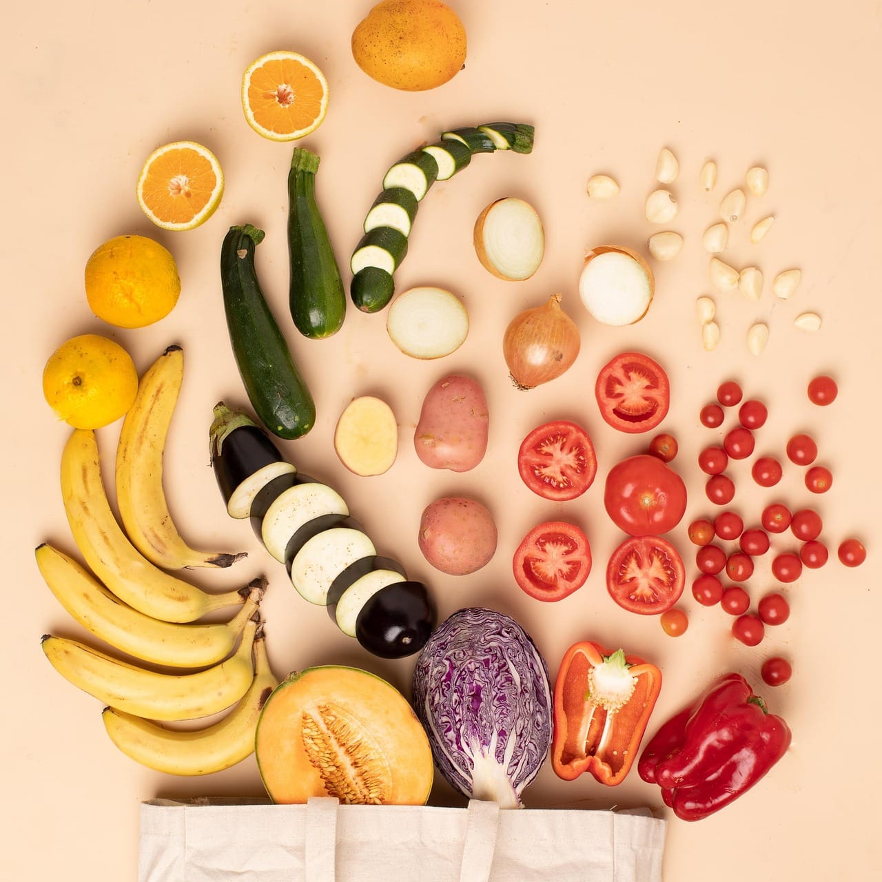 Fresh colorful vegetables and leafy greens arranged on a wooden table