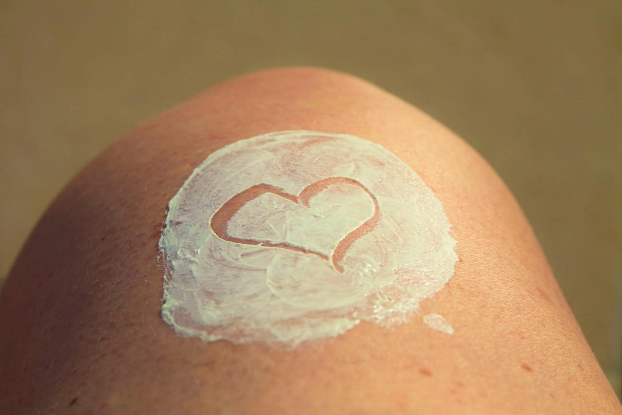 Close-up of a woman smoothing cream onto her cheek
