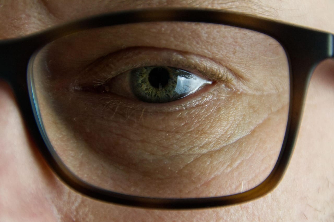 A detailed close-up of a person's bright blue eye and lashes