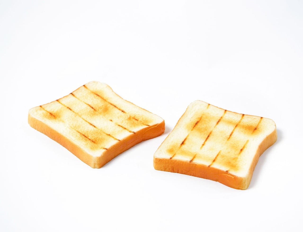 A single slice of dry toast on a white plate