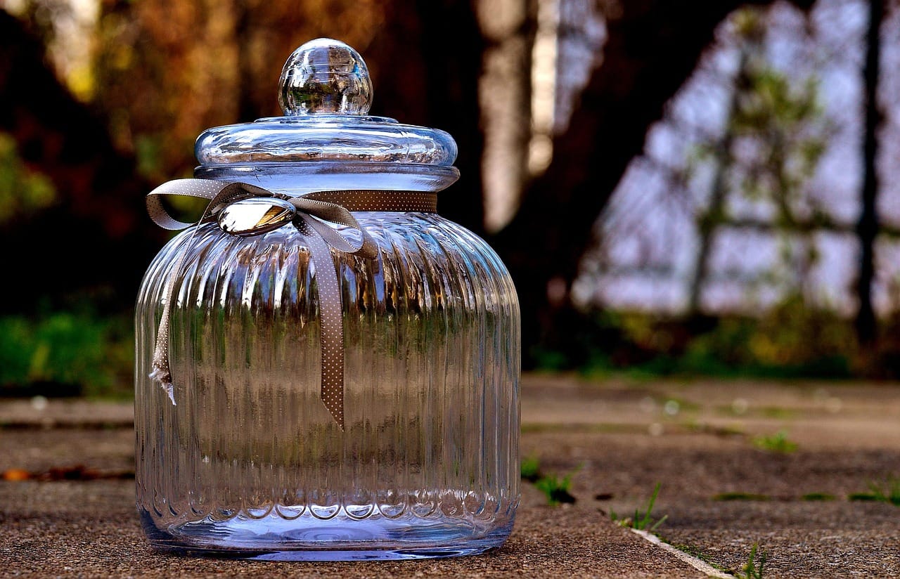 Loose dried herbal tea stored in a sealed glass jar