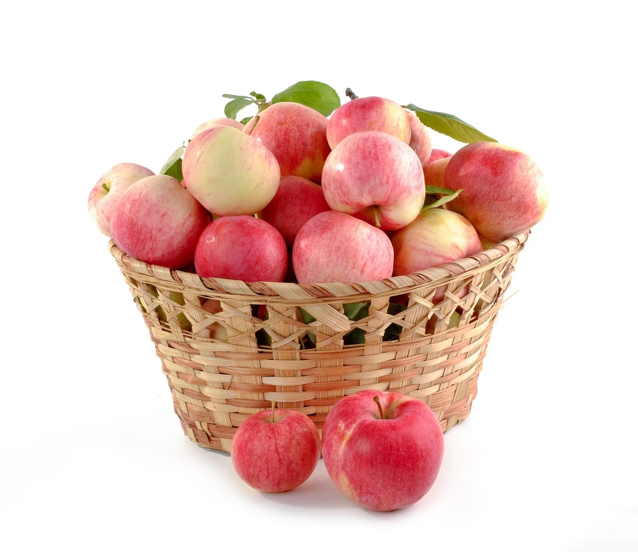 A wicker basket filled with freshly picked small orchard apples
