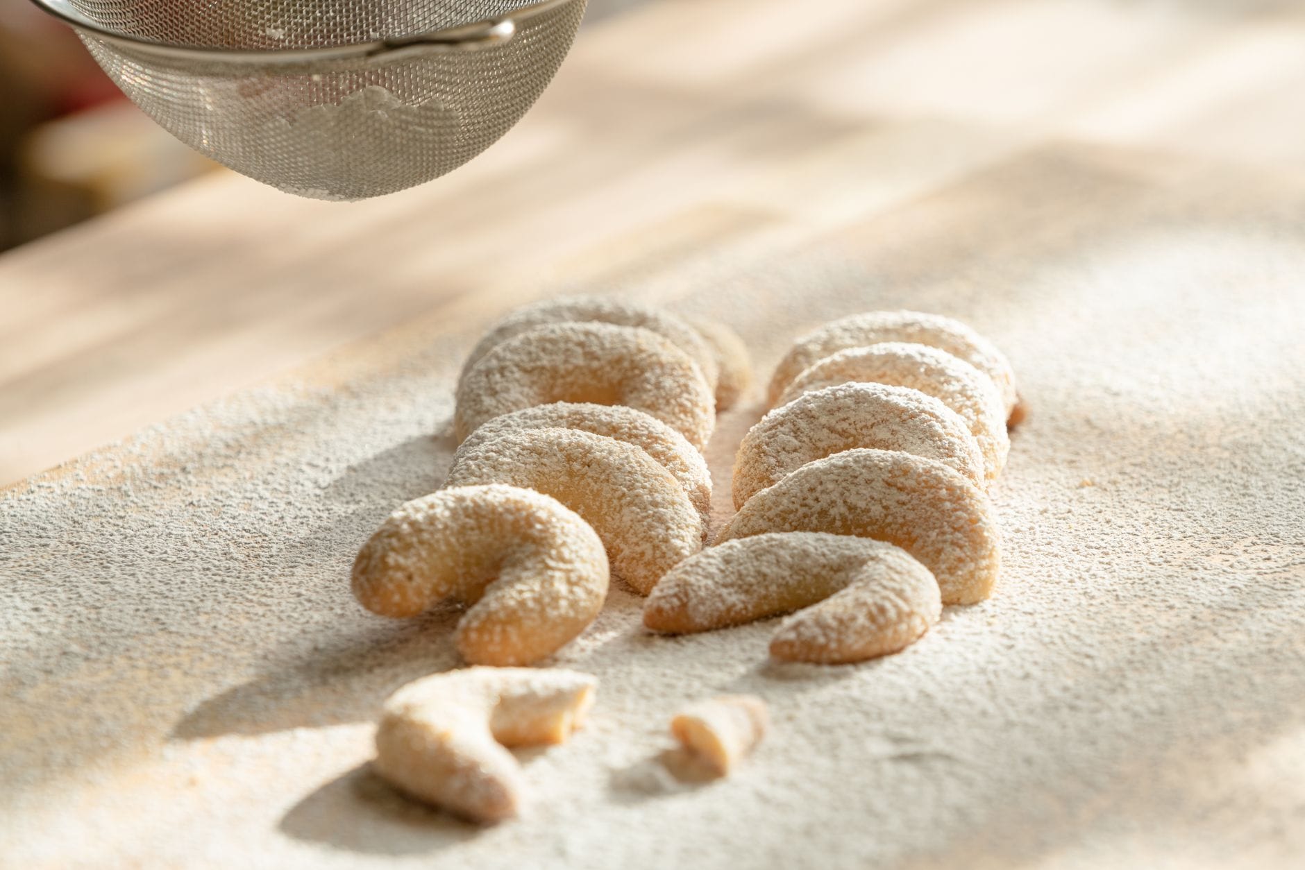 Golden almond flour cookies cooling on a parchment-lined baking tray