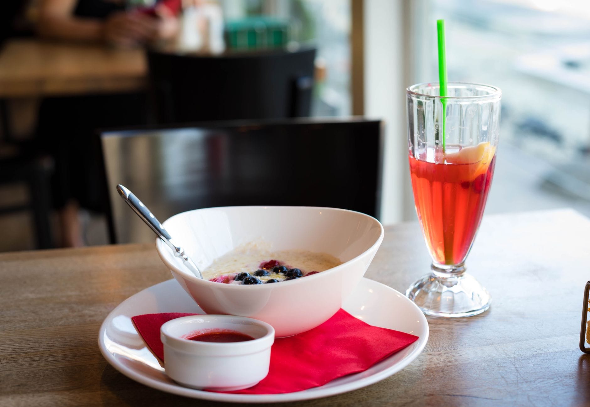 A bowl of oatmeal topped with fresh berries on a table