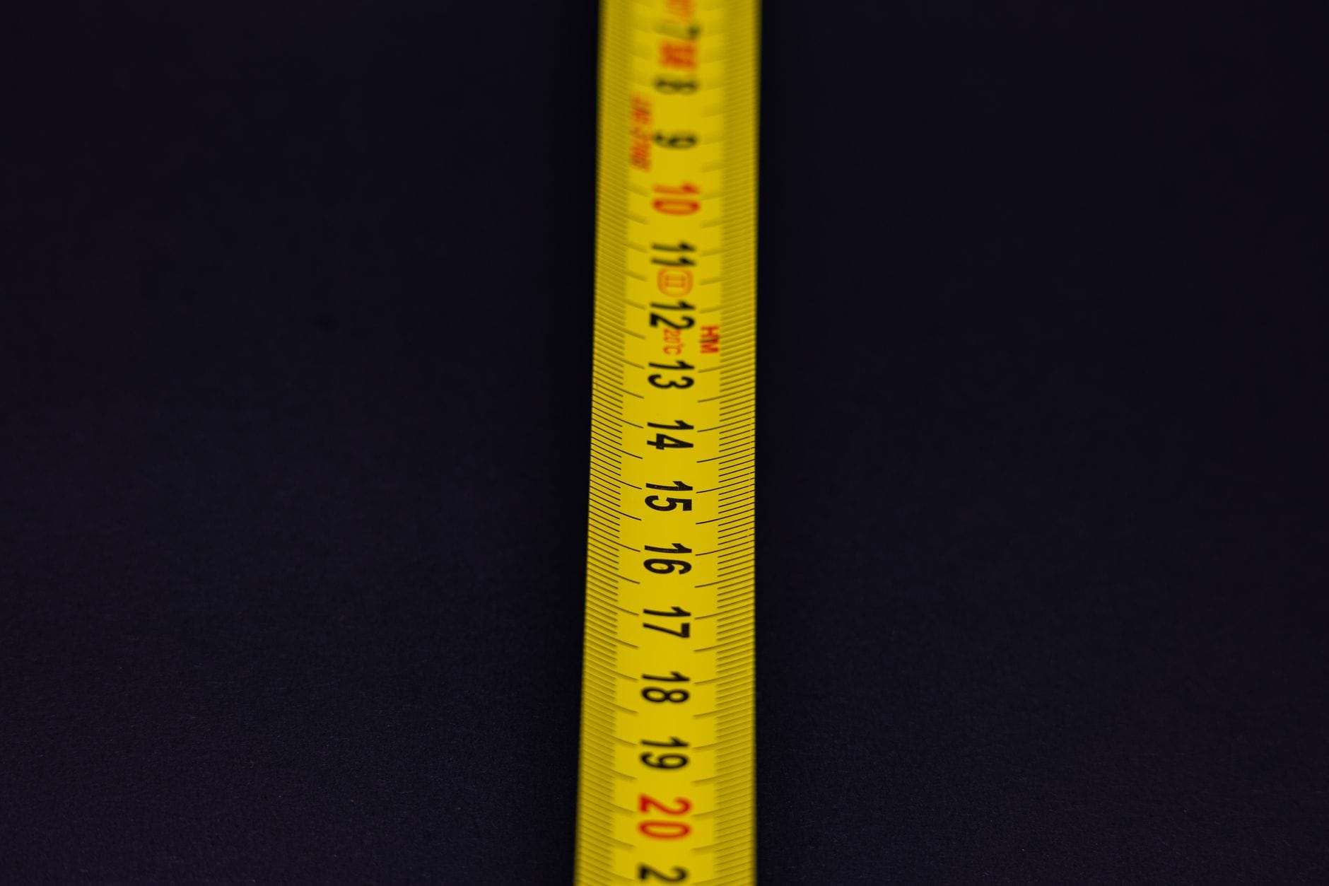 A cloth tape measure wrapped around a bathroom weighing scale