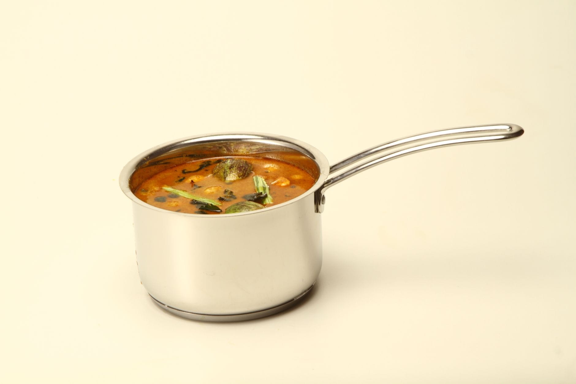 Cooked fenugreek greens served in a bowl on a wooden table