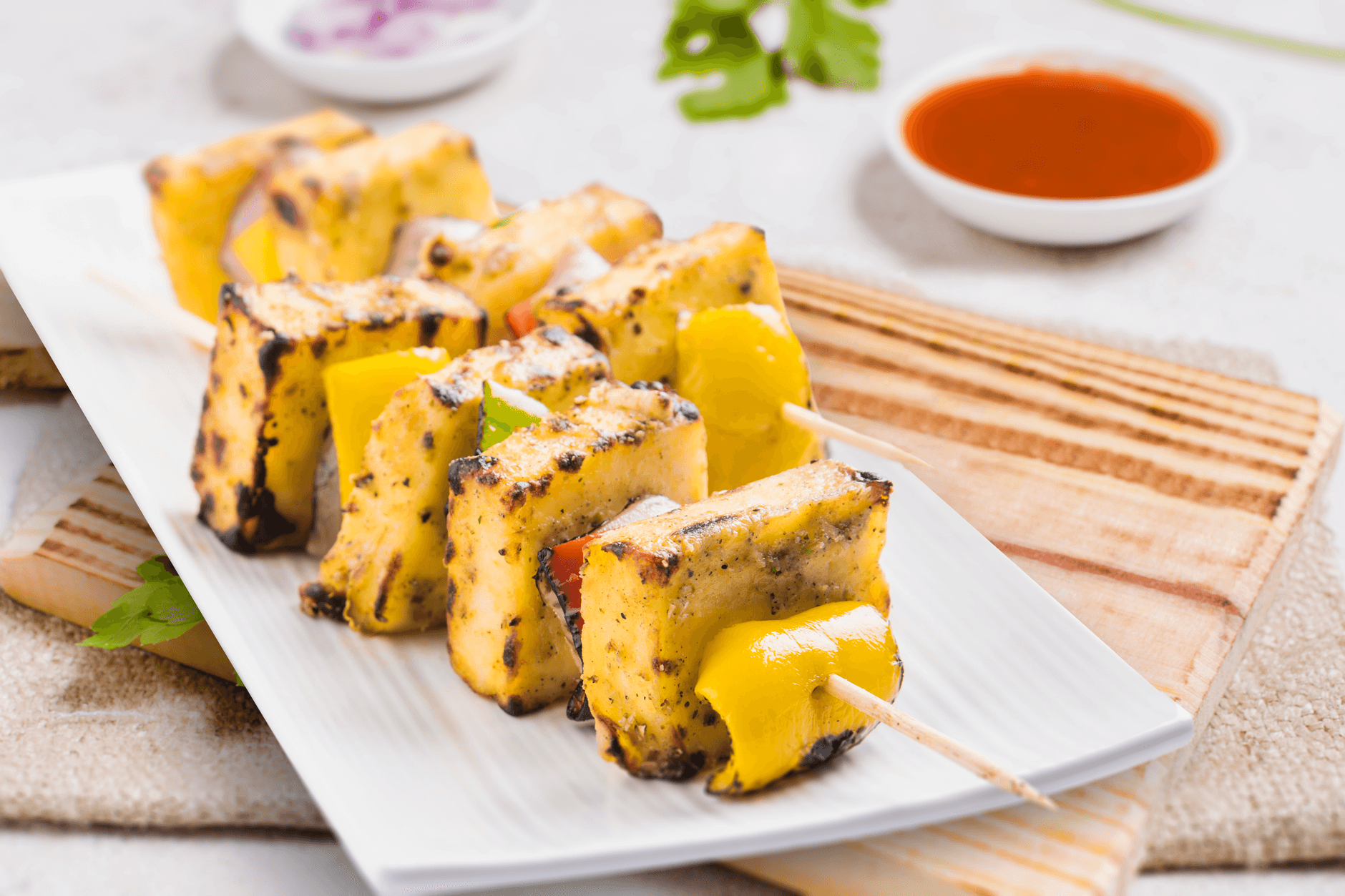 Grilled paneer and pepper cubes on skewers with char marks