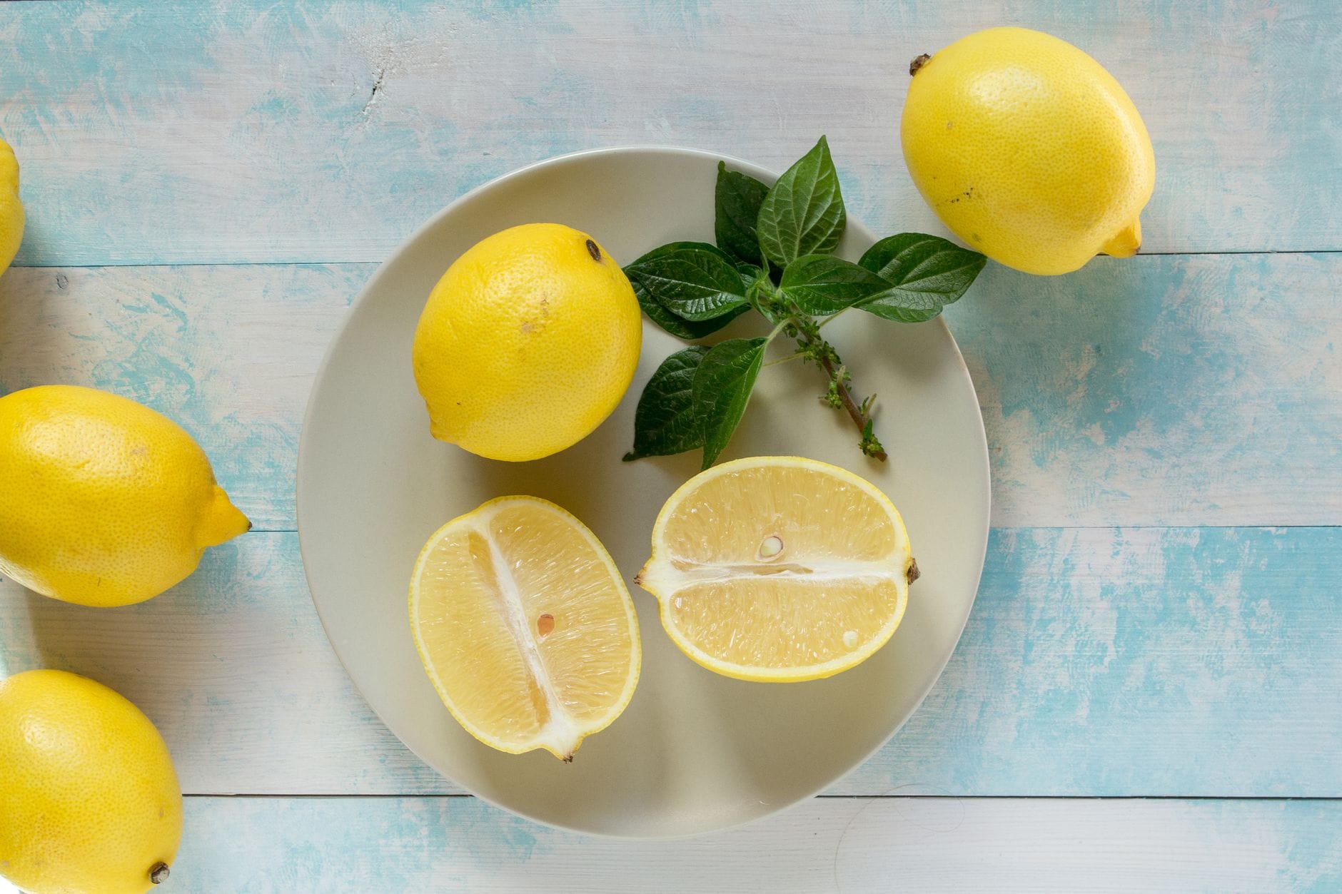 Bright yellow lemon sliced open on a wooden cutting board