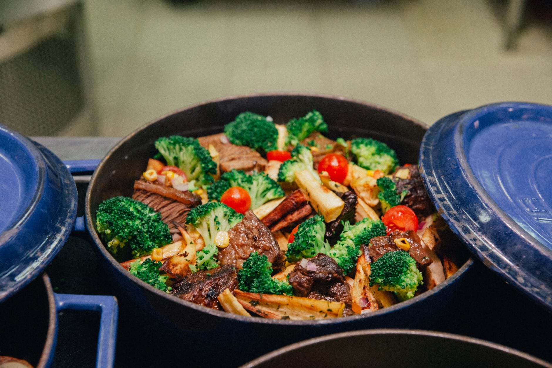 Golden baked broccoli casserole steaming in a white ceramic dish