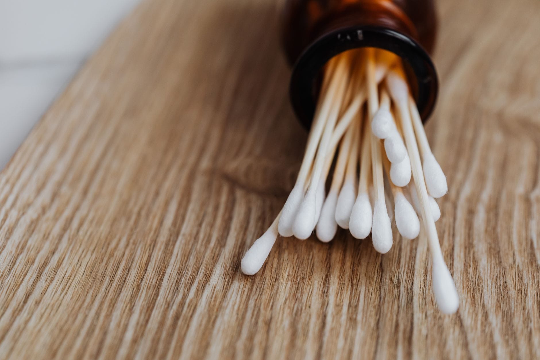 white cotton swabs standing upright in a clear glass jar