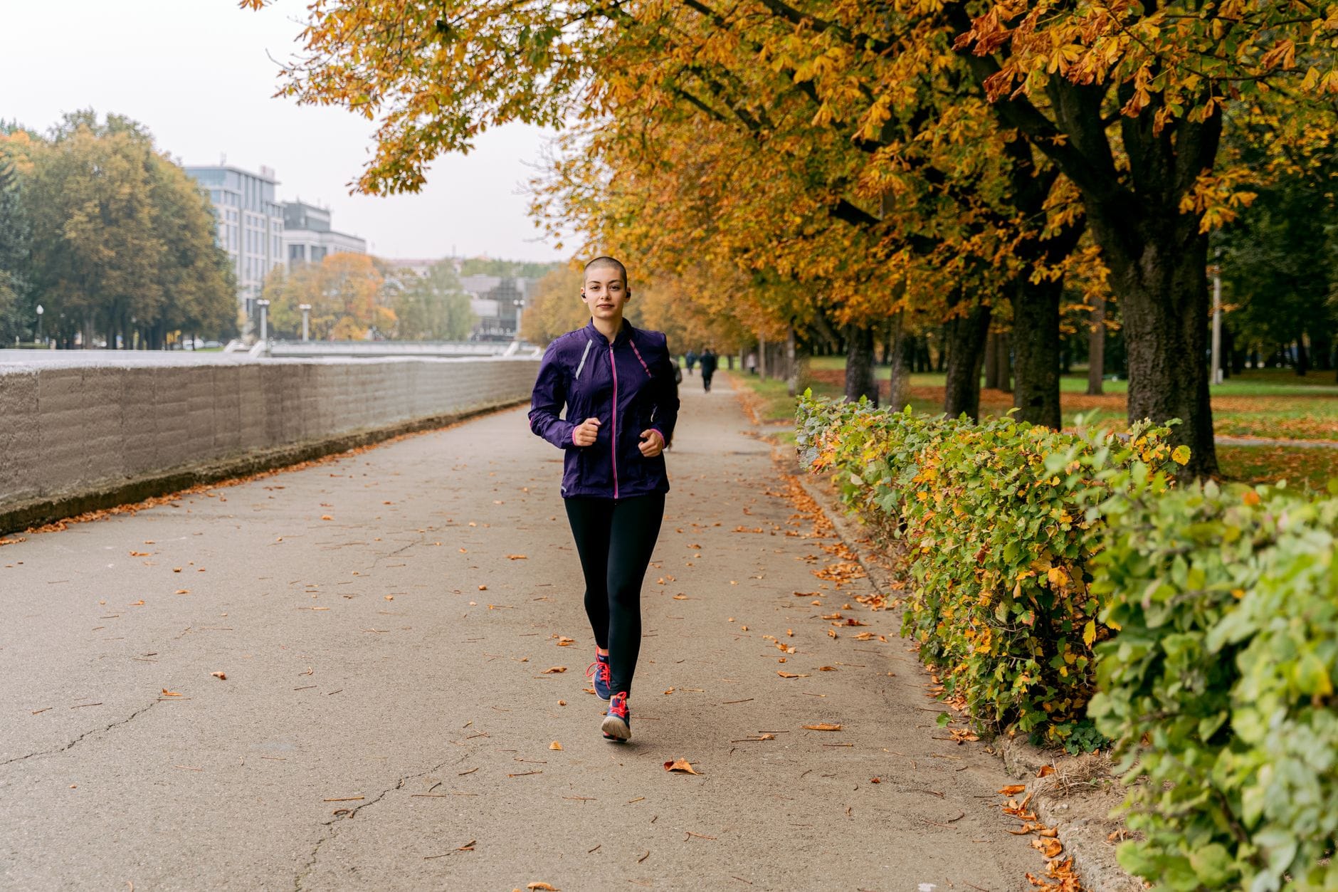 woman running along a sunny path with energy and focus