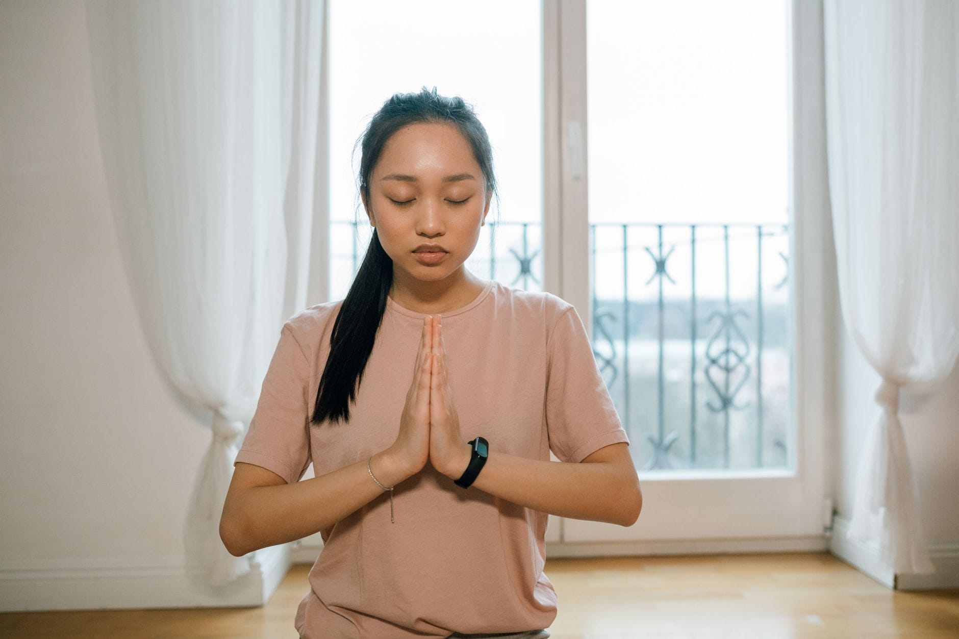 person sitting with eyes closed taking a slow deep breath