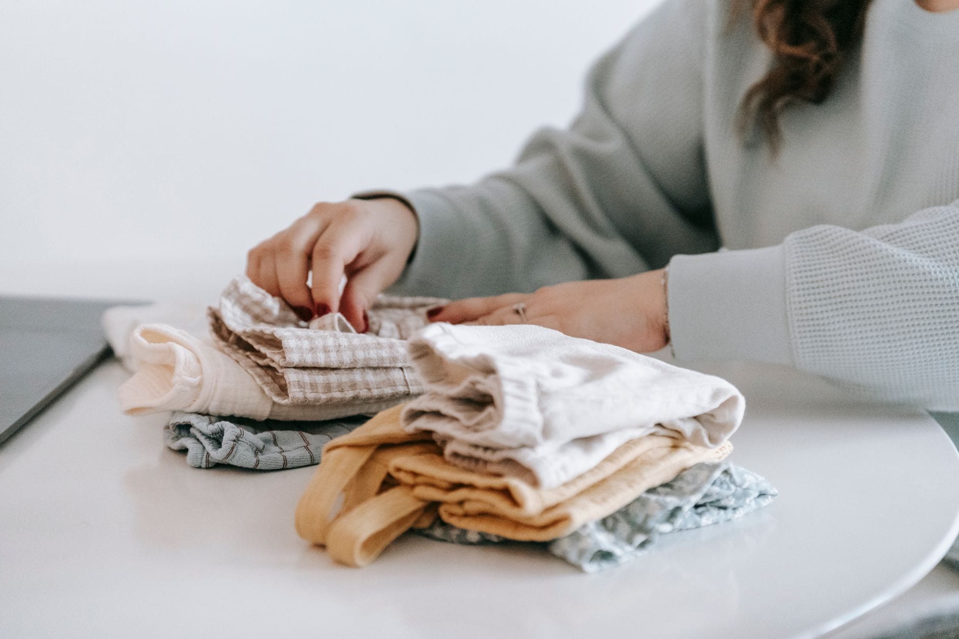 Neatly folded white cotton underwear stacked on a wooden surface