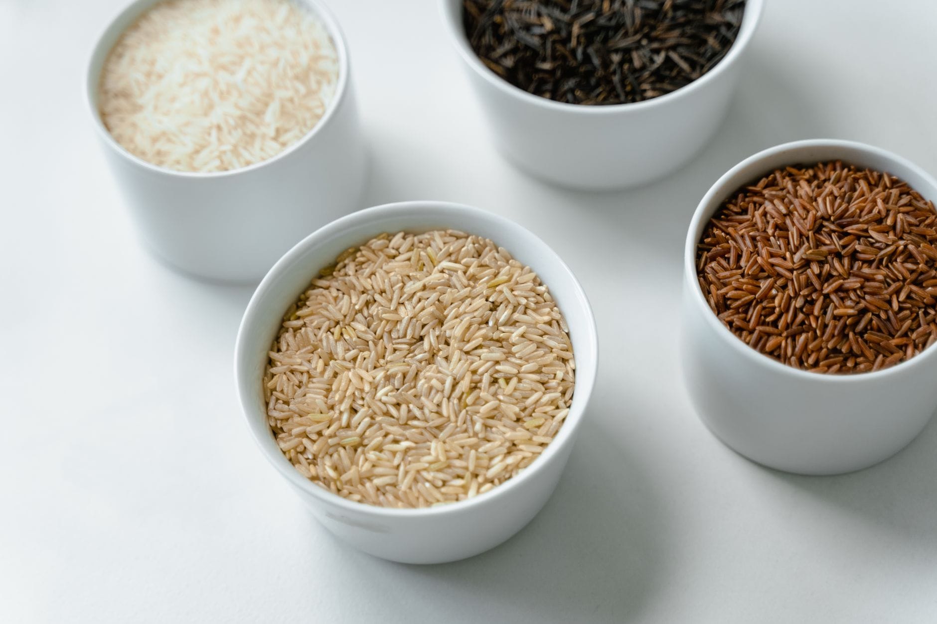 Steaming brown rice in a wooden bowl on a table