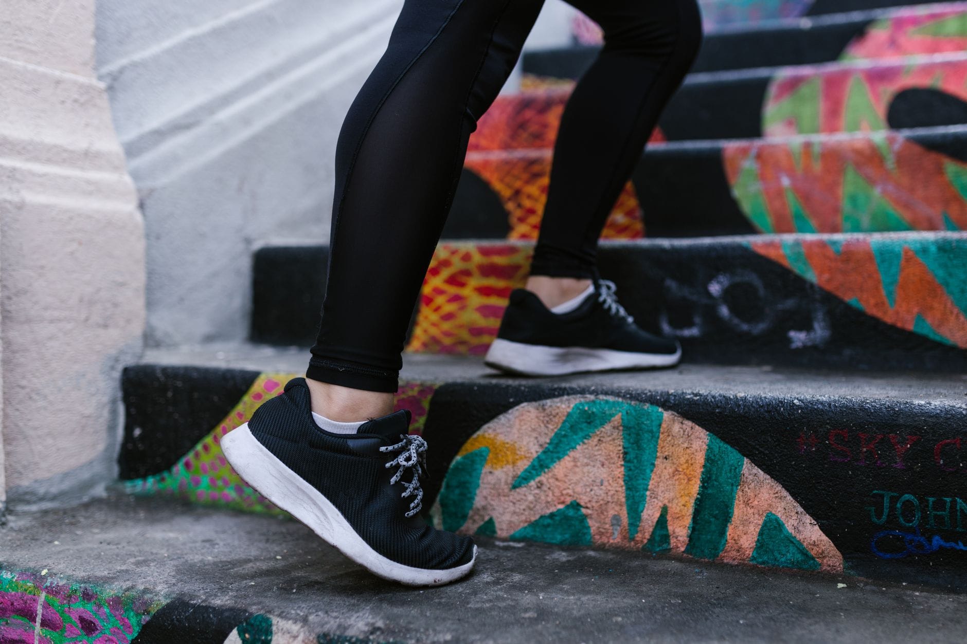 A person walking up a flight of concrete steps outdoors