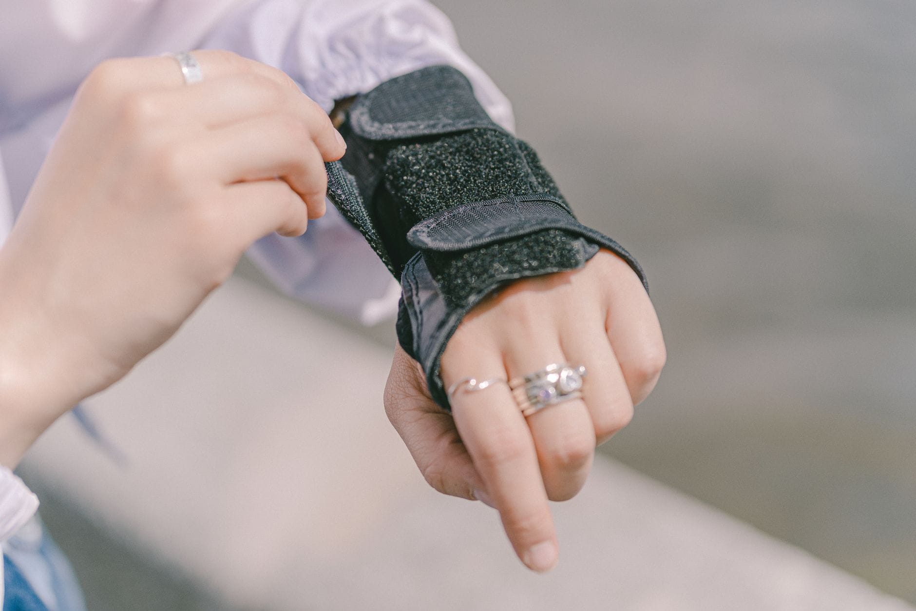 Beige wrist brace fastened around a person's forearm and hand