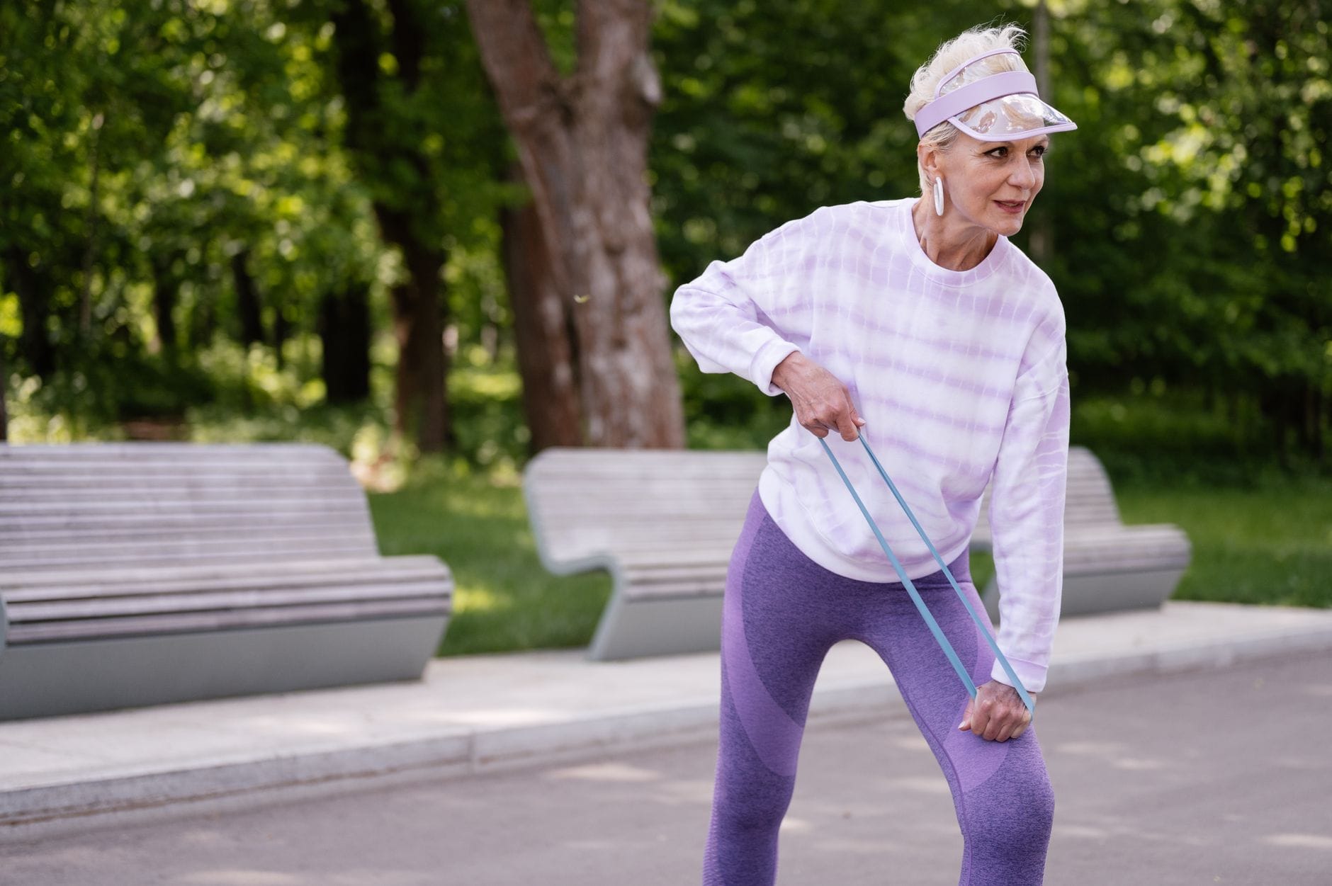 Person looping a blue resistance band around the foot during rehab