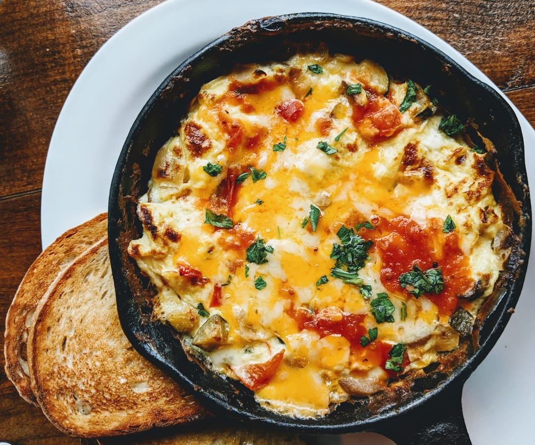 A single egg frying sunny side up in a cast iron pan