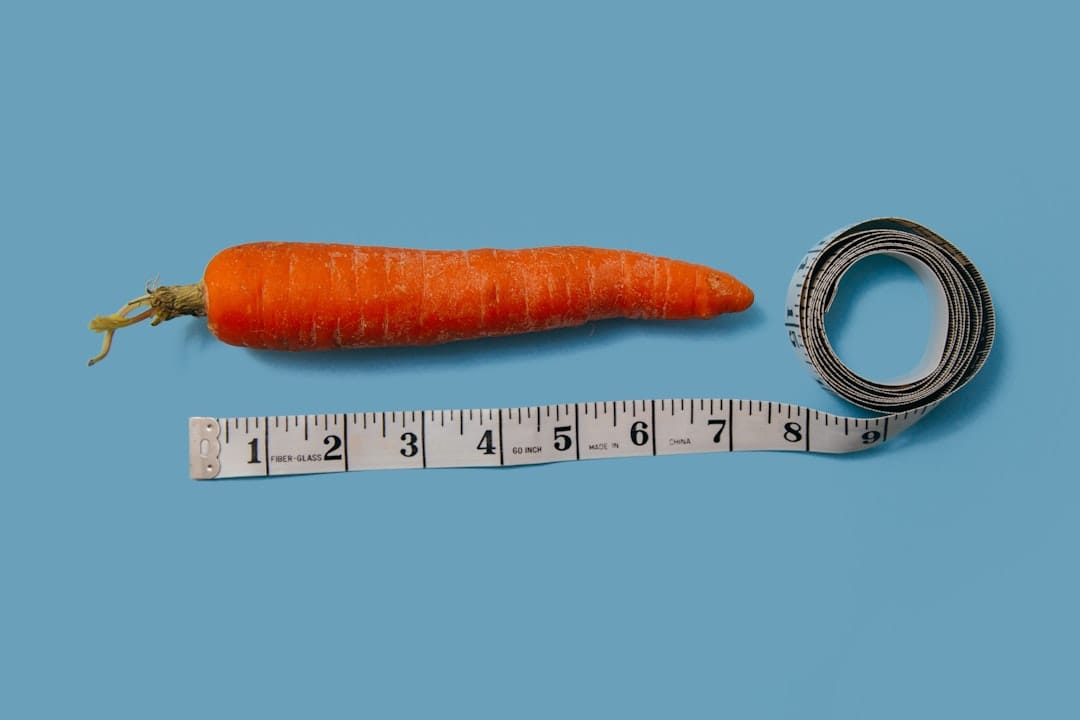 Measuring tape wrapped around fresh vegetables on a kitchen counter