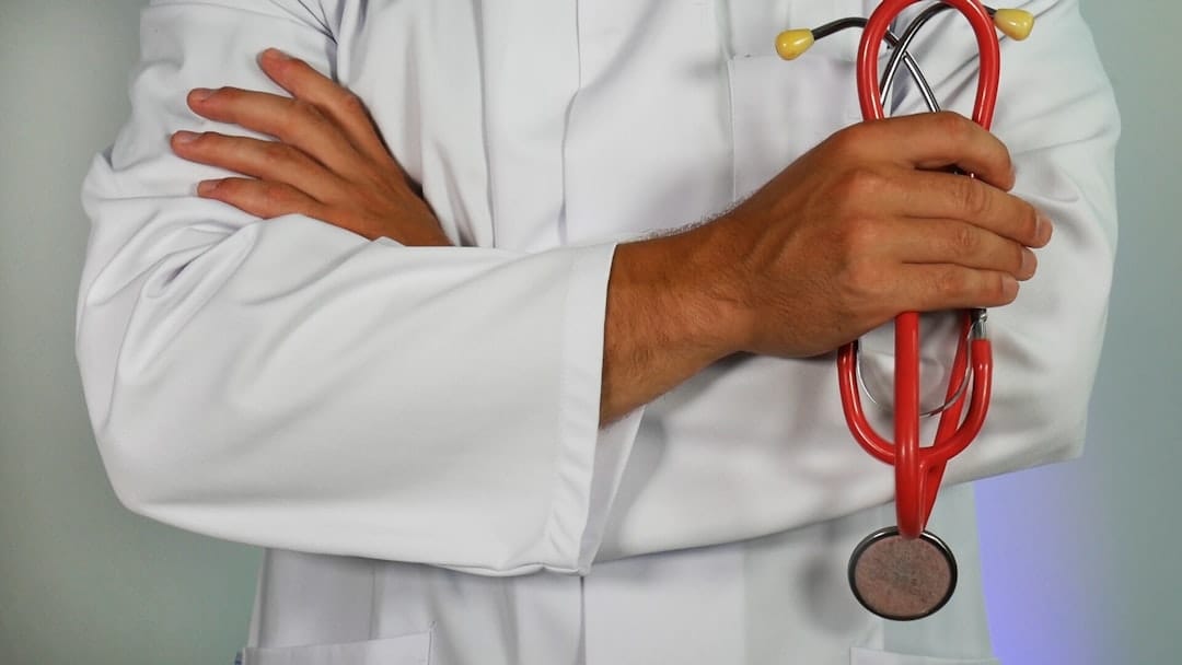 A doctor presses a stethoscope against a smiling patient's chest