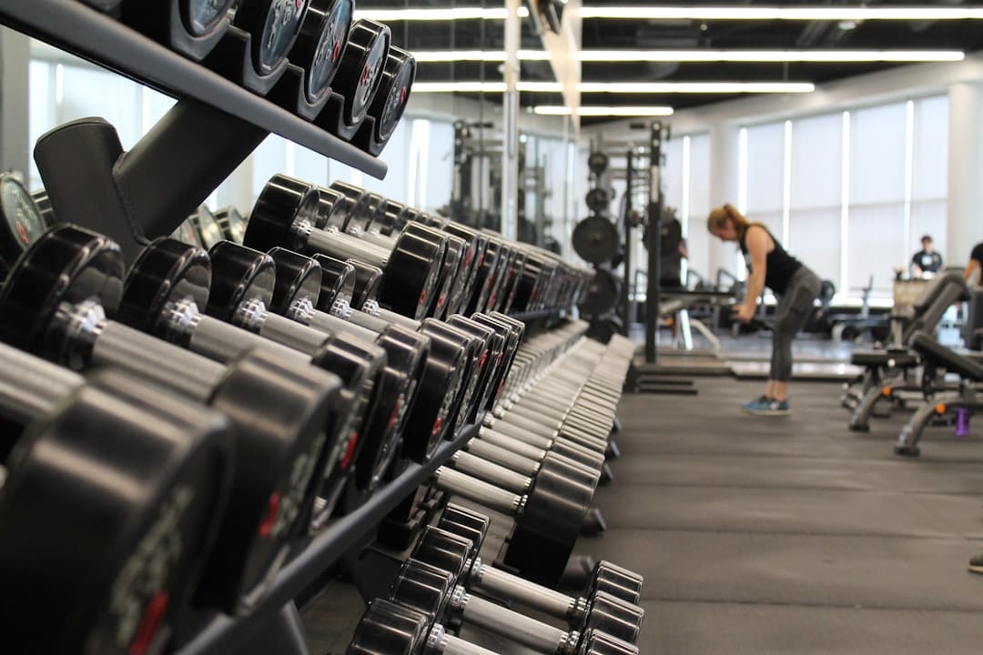 Athlete lifting a barbell in a gym during a strength workout