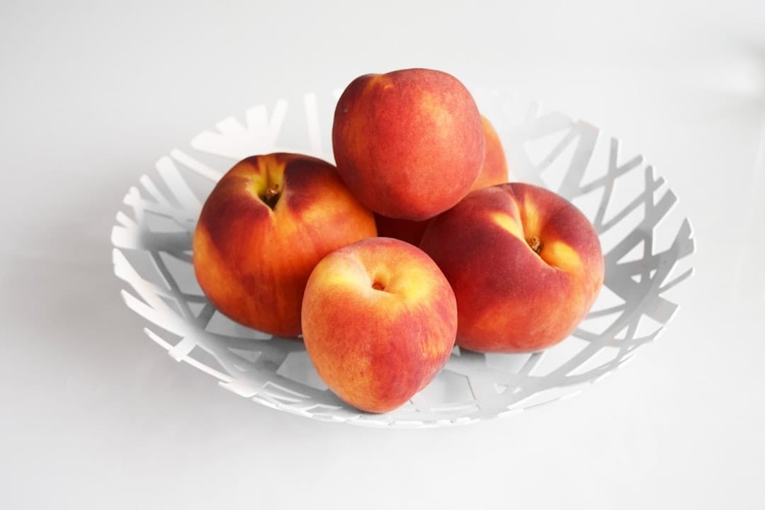 Soft canned peach slices served in a small glass bowl