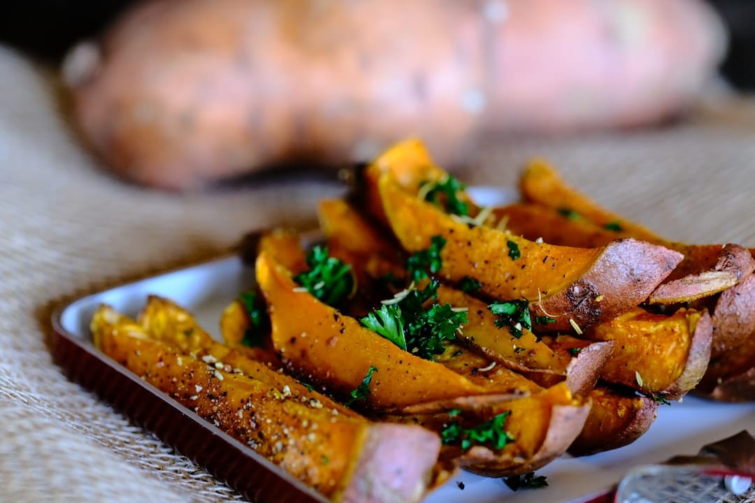 Crispy golden yam fries arranged on a rustic ceramic plate
