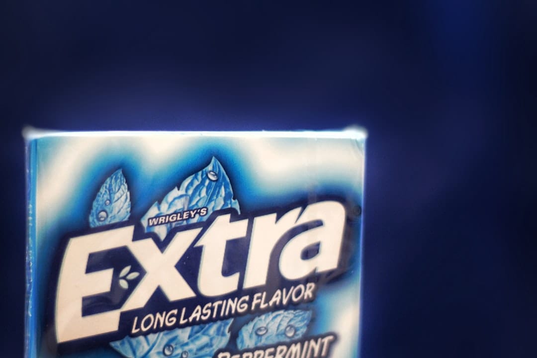 Blister pack of white chewing gum pieces resting on a plain surface