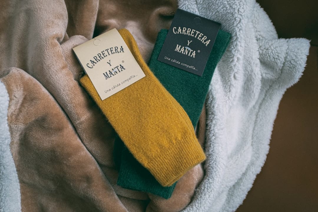 Neatly folded pairs of cotton socks stacked in soft daylight