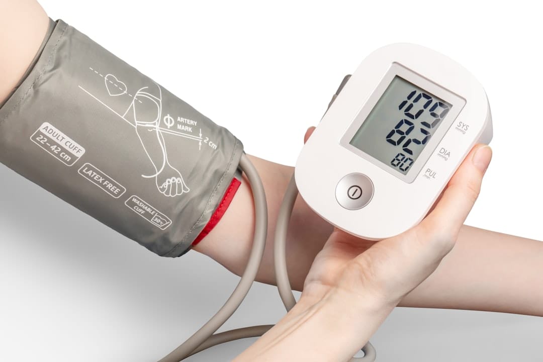 A nurse checks a patient's blood pressure with an arm cuff