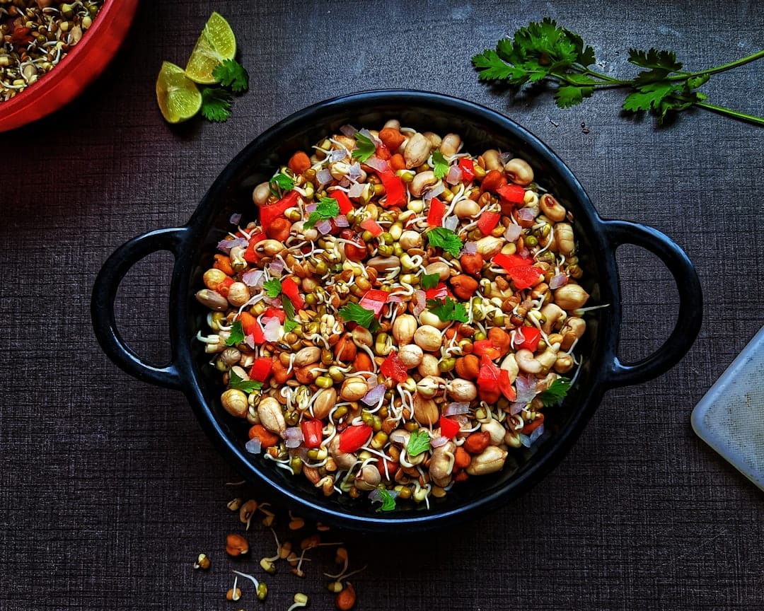 Bowls of mixed whole grains and dried lentils on a rustic kitchen counter