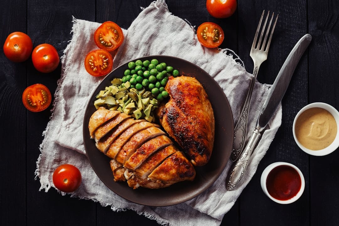 Sliced grilled chicken breast resting on a white plate
