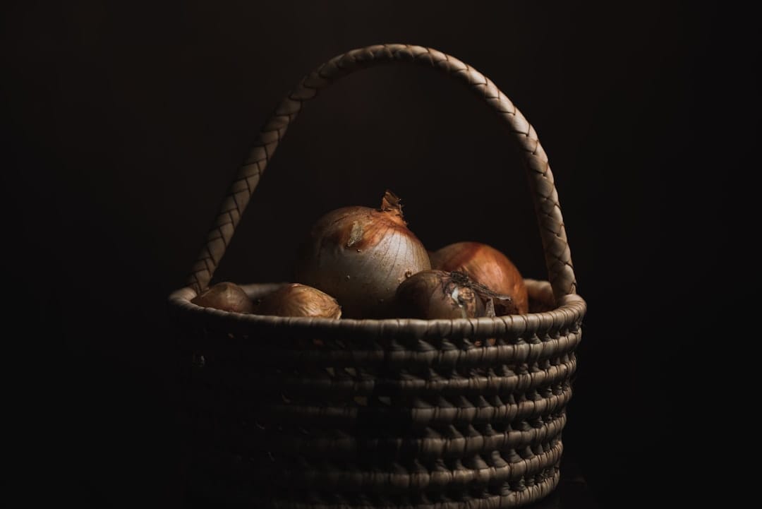 Assorted colorful root vegetables piled in a rustic woven basket