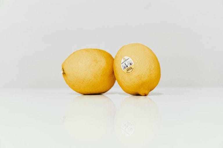 Halved bright yellow lucuma fruit showing its dense golden flesh and dark seed