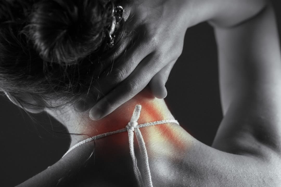 Blue gel ice pack resting against the back of a person's neck