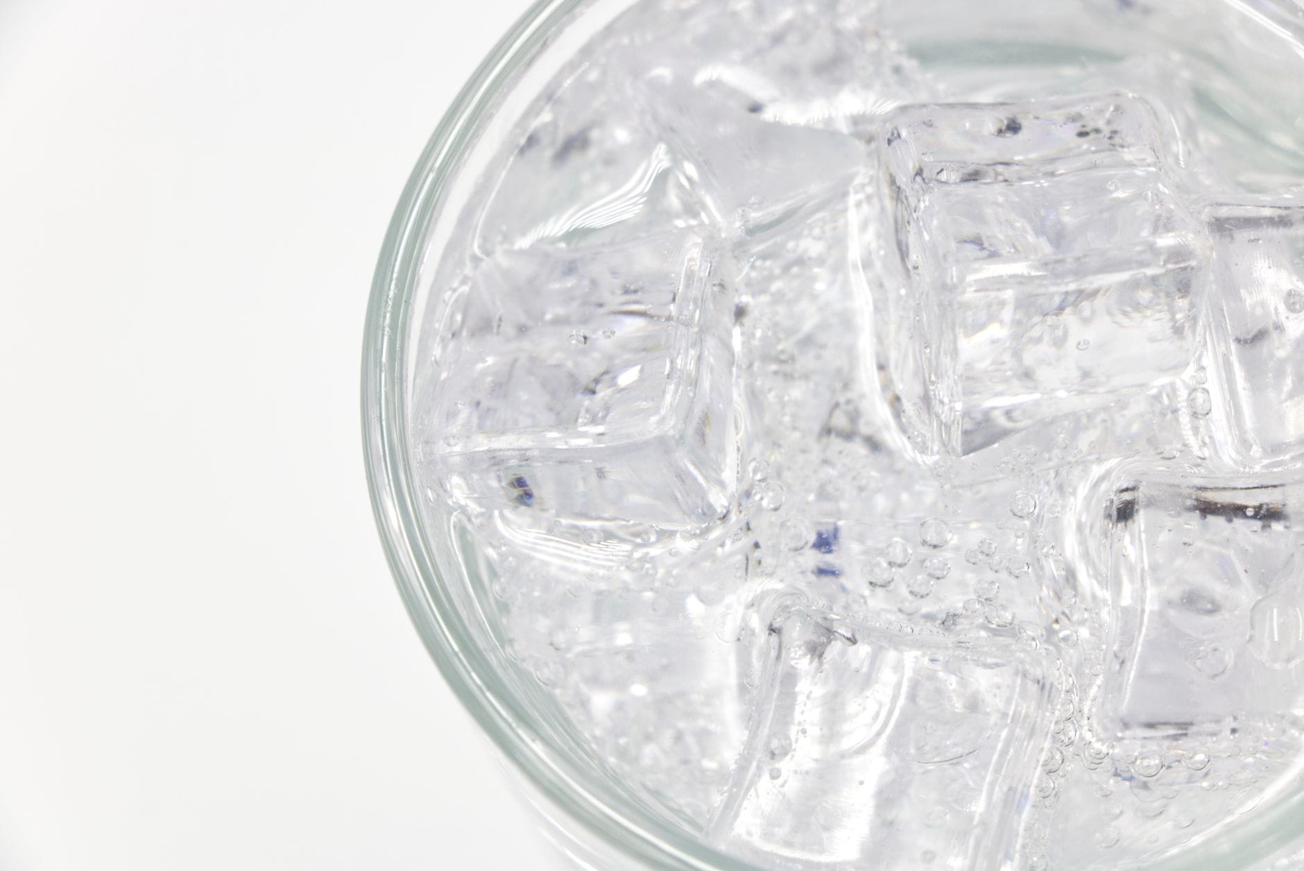 A glass of sparkling water over ice with fresh mint