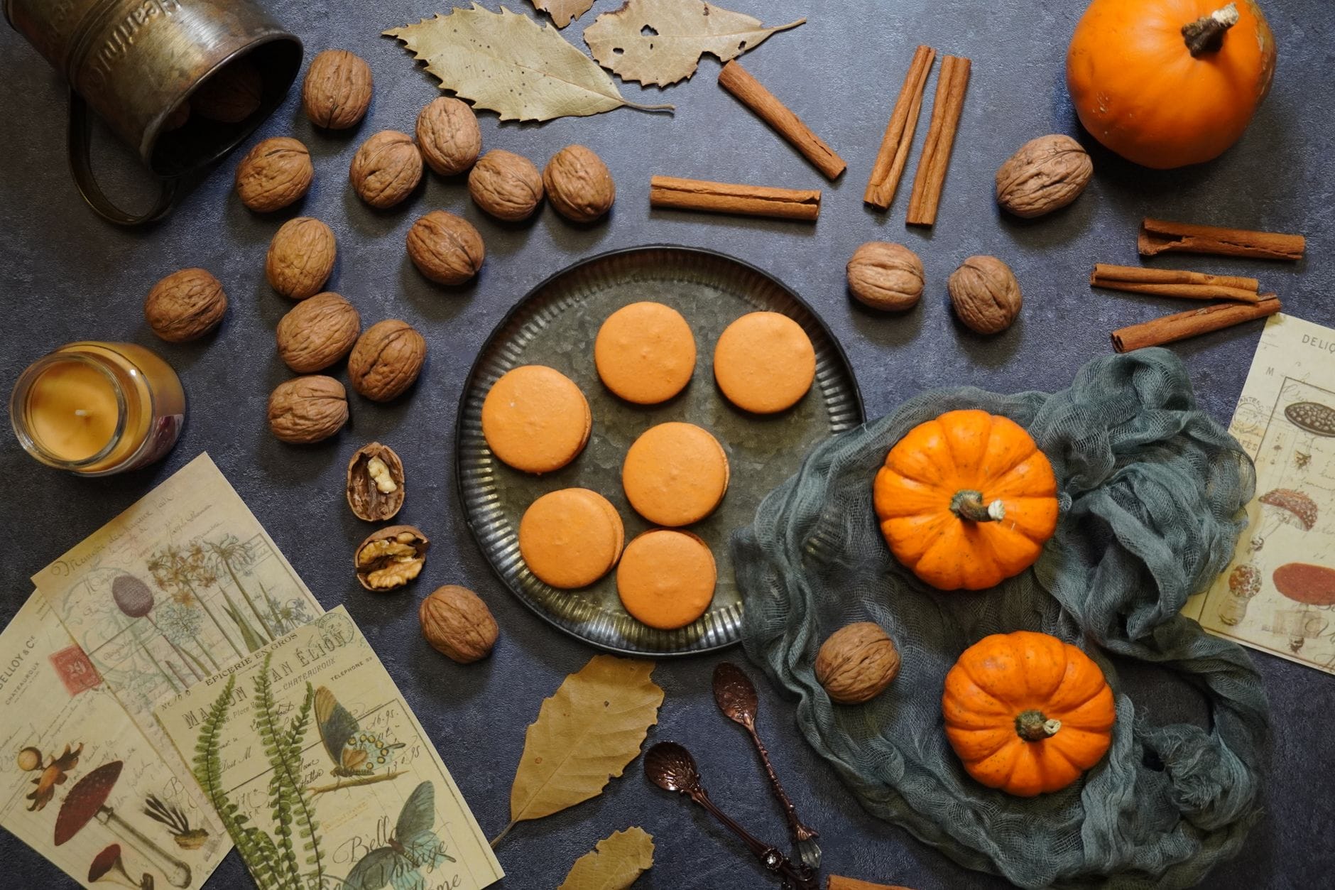 Soft spiced pumpkin cookies cooling on parchment paper with cinnamon sticks nearby