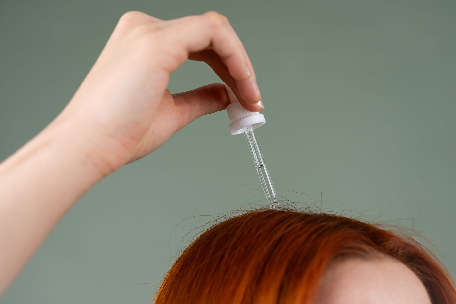 Close-up of an adult parting a child's hair to check the scalp for lice