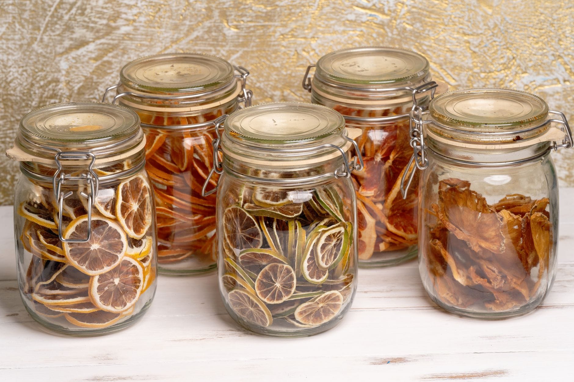 Glass airtight storage jars on a pantry shelf