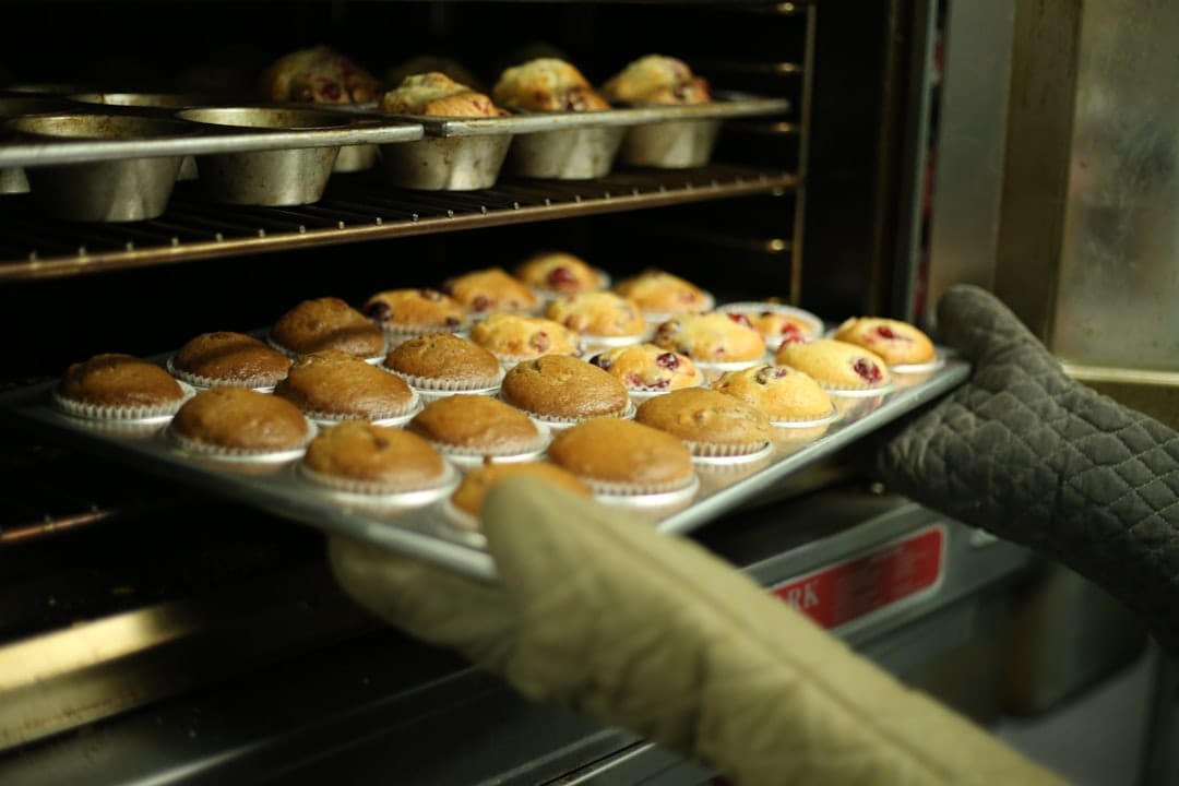 Freshly baked muffins cooling on a wire rack in a bright kitchen